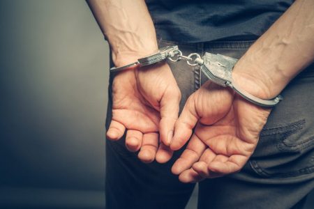 shutterstock_437224012-min Man in Handcuffs